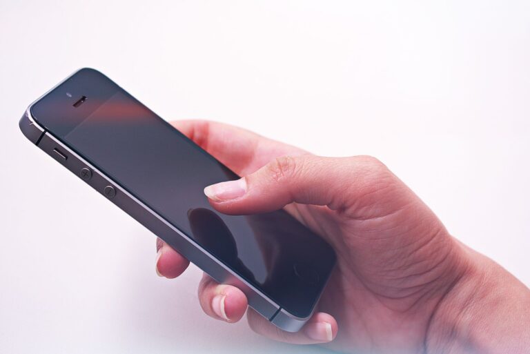 A persons hand holding a smartphone, showcasing modern technology and connectivity.